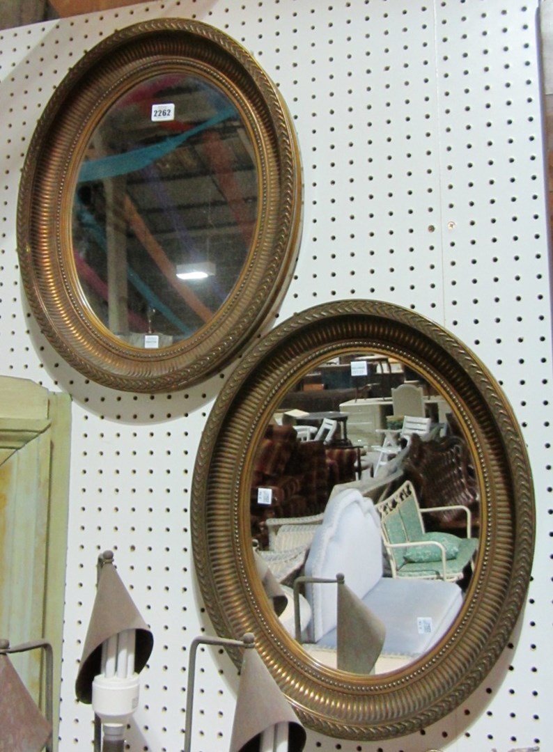 Appraisal: A pair of oval gilt mirrors