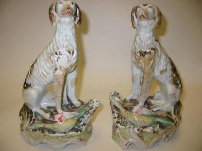 Appraisal: A PAIR OF STAFFORDSHIRE POTTERY MODELS OF SALUKIS c seated