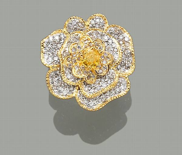 Appraisal: A yellow sapphire diamond and fourteen karat white gold articulated