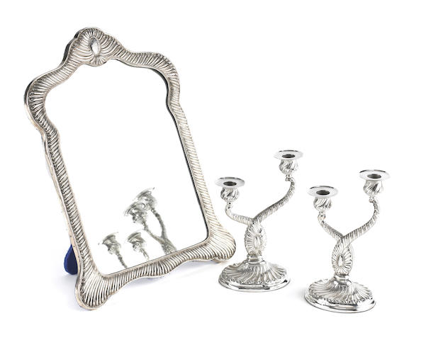 Appraisal: A Victorian silver-mounted mirror and pair of two-light candelabra by