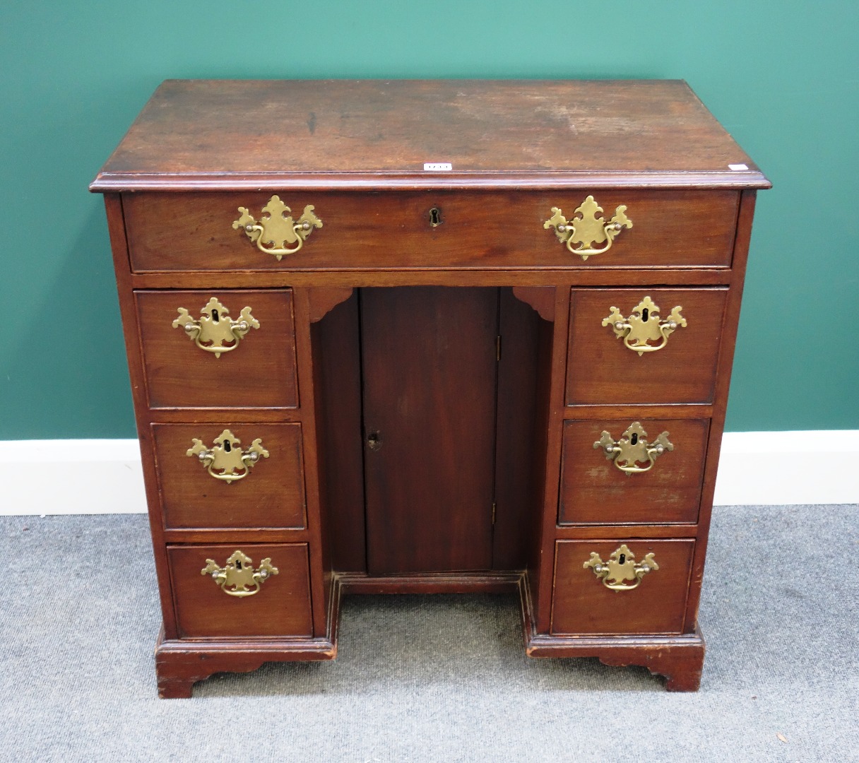 Appraisal: A mid- th century mahogany kneehole writing desk with seven