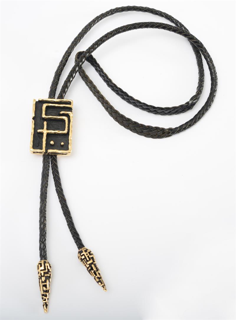 Appraisal: K GOLD AND METAL BOLO TIE Signed 'Andrew' and stamped