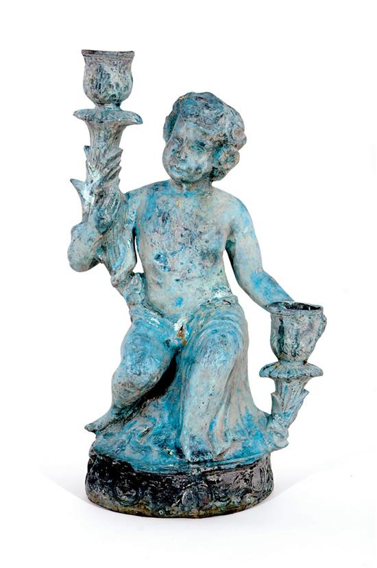 Appraisal: Painted metal putto seated upon and supporting cornucopia H W