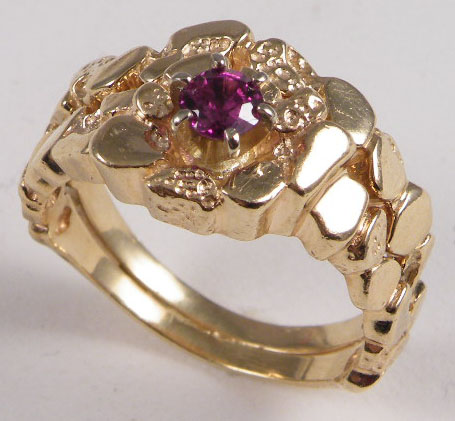 Appraisal: GARNET AND FOURTEEN KARAT GOLD RING centering a round brilliant-cut