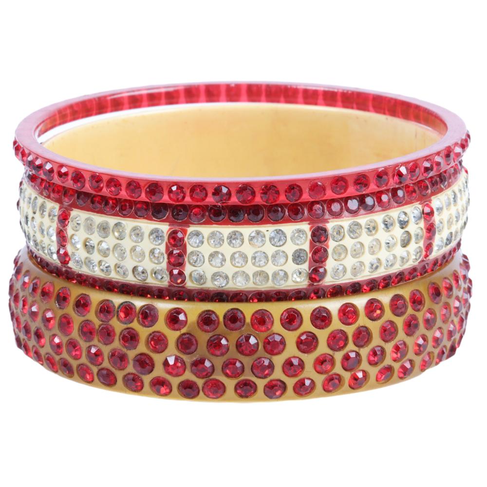 Appraisal: THREE RED AND APPLE JUICE CELLULOID SPARKLER BANGLE BRACELETS INNER