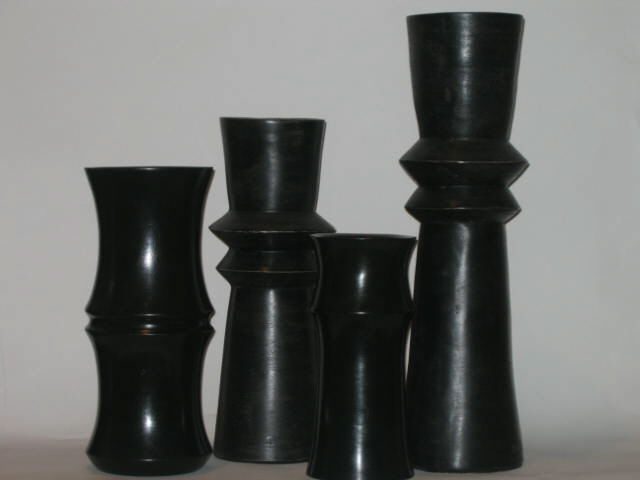 Appraisal: FOUR DECORATIVE VASES various shaped columnar designs pottery and wood