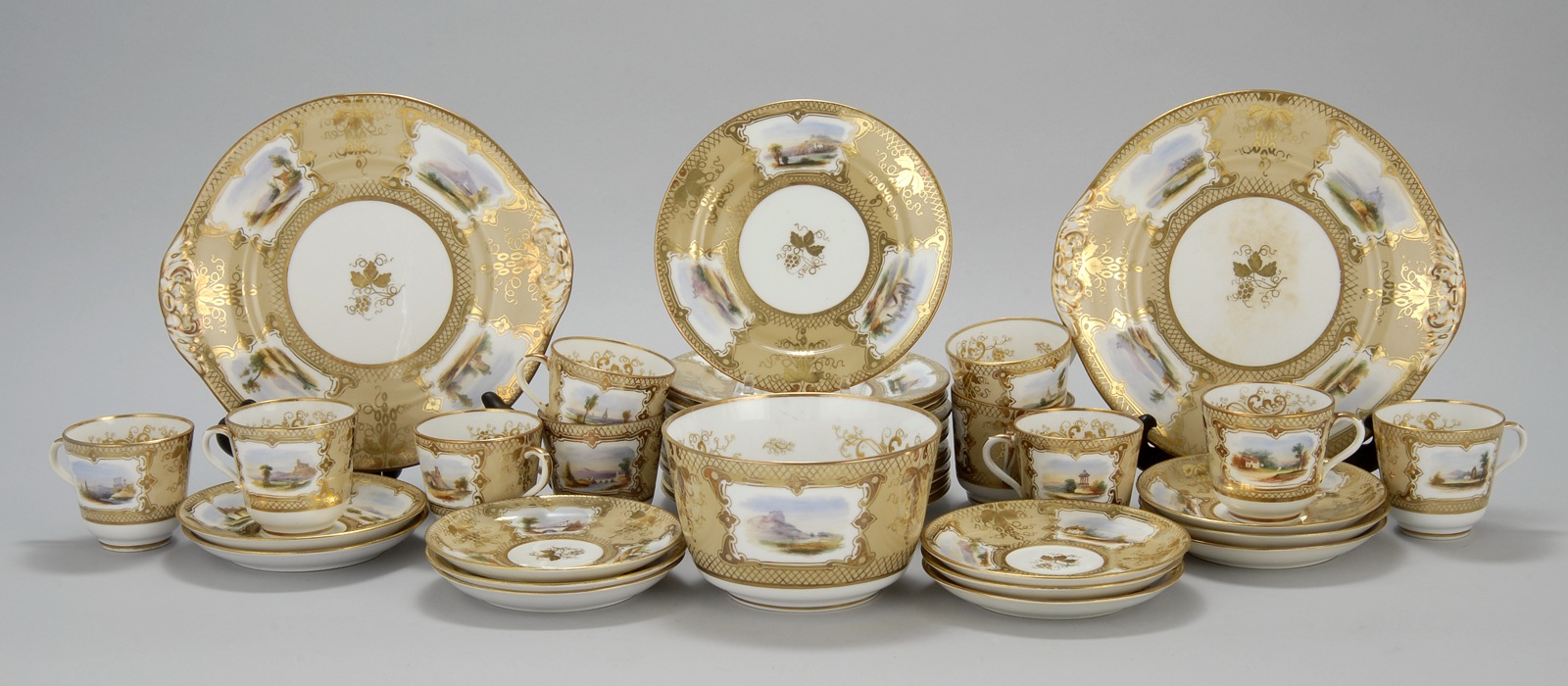 Appraisal: ENGLISH PORCELAIN DESSERT SET th CenturyWith hand-painted landscape cartouches and