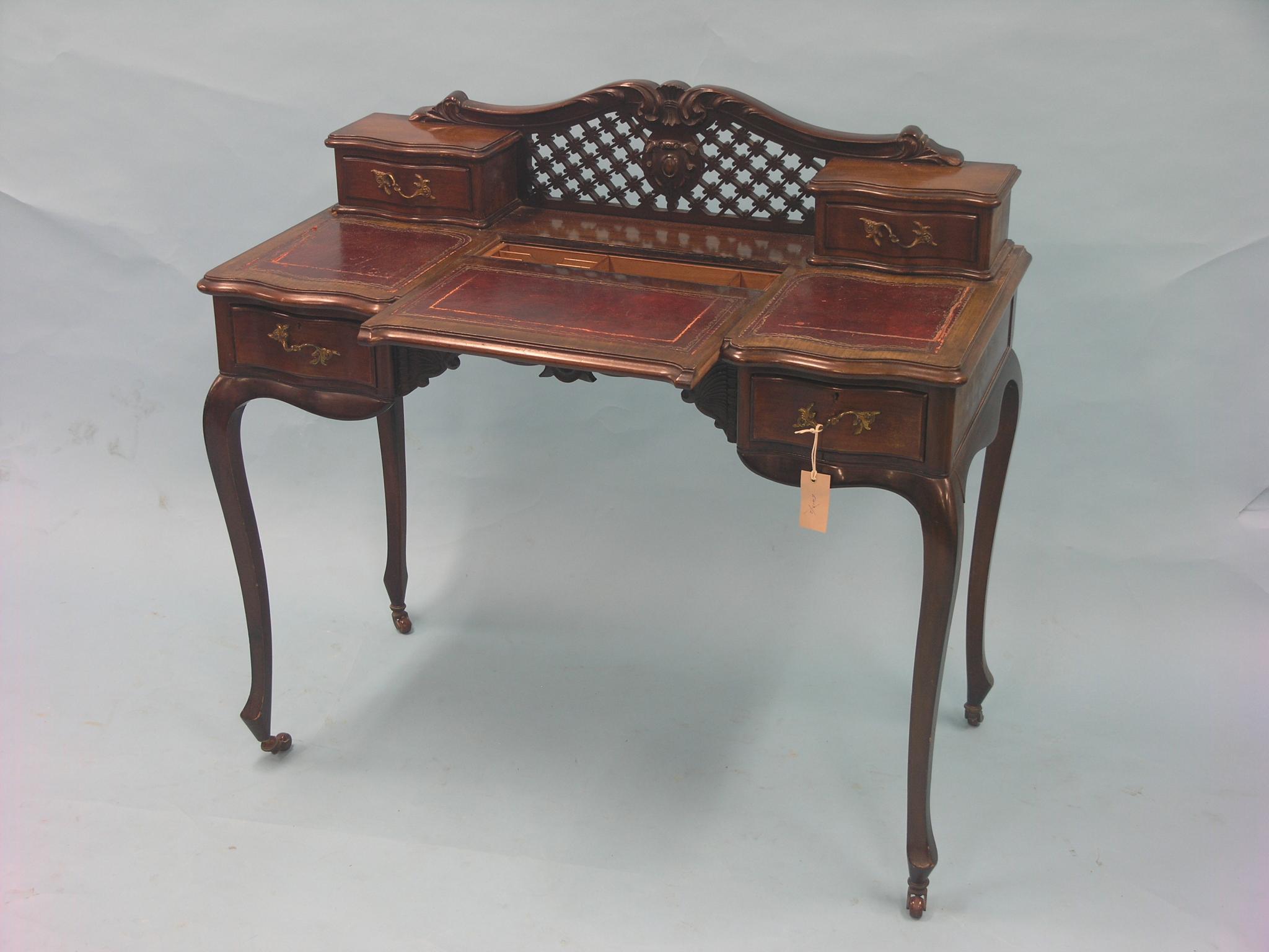 Appraisal: A late Victorian lady's mahogany writing table serpentine-shaped top with