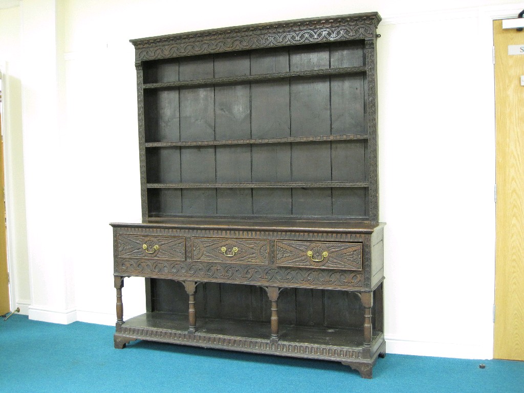 Appraisal: An antique oak Dresser with boarded rack having carved frieze