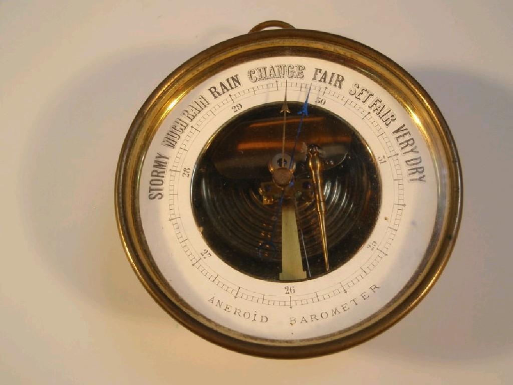 Appraisal: A brass cased aneroid barometer fitted with suspension ring cm