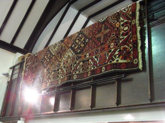 Appraisal: A PAKISTAN RED GROUND WOOL CARPET with large central panel