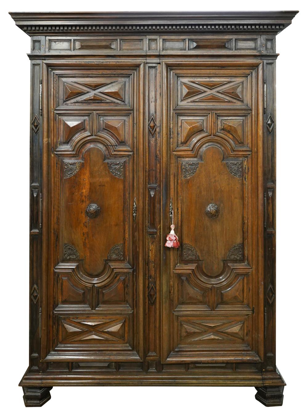 Appraisal: LOUIS XIII-STYLE CARVED WALNUT ARMOIREthe doors enclosing a fabric-lined interior