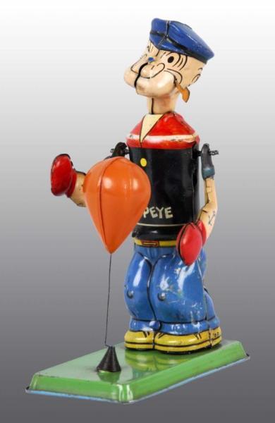 Appraisal: Tin Chein Popeye Puncher Wind-Up Toy Description American Working Green