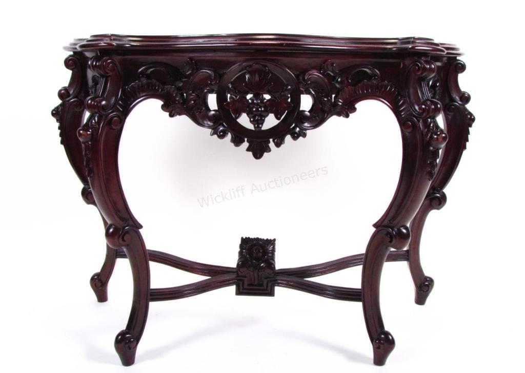 Appraisal: A carved mahogany console table with reticulated carvings dark finish