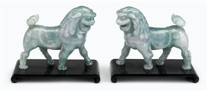 Appraisal: Pair of Chinese carved green jadeite models of Fu lionsearly