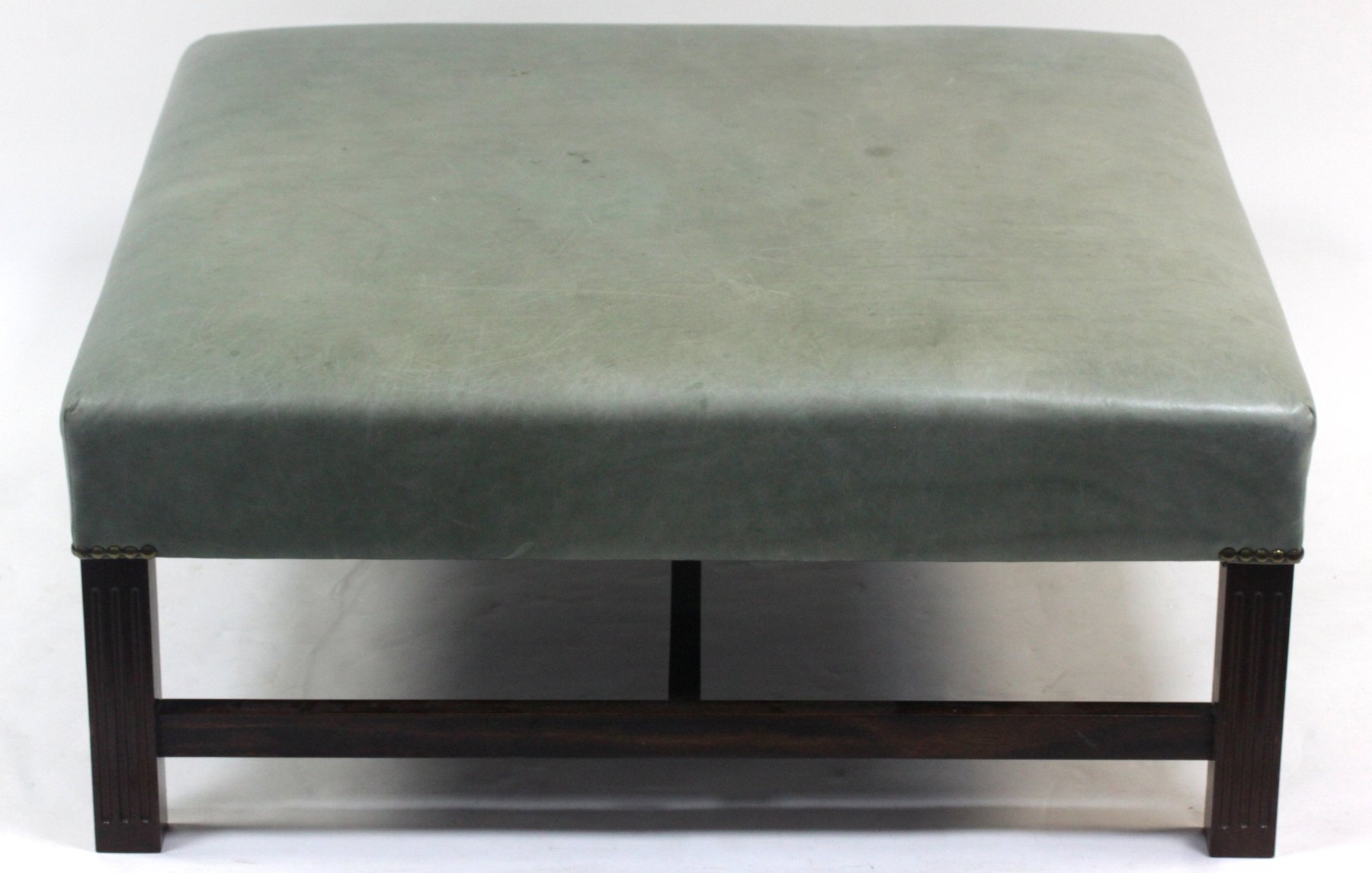 Appraisal: A George III style leather upholstered stool on square fluted