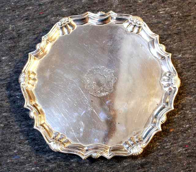 Appraisal: A GEORGE II SILVER SALVER with Chippendale shell border and