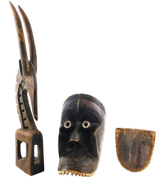 Appraisal: TRIBAL Two carved and pierced wooden sculptures and masks the