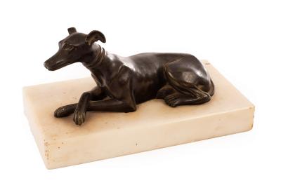 Appraisal: A bronze figure of a recumbent whippet the white marble