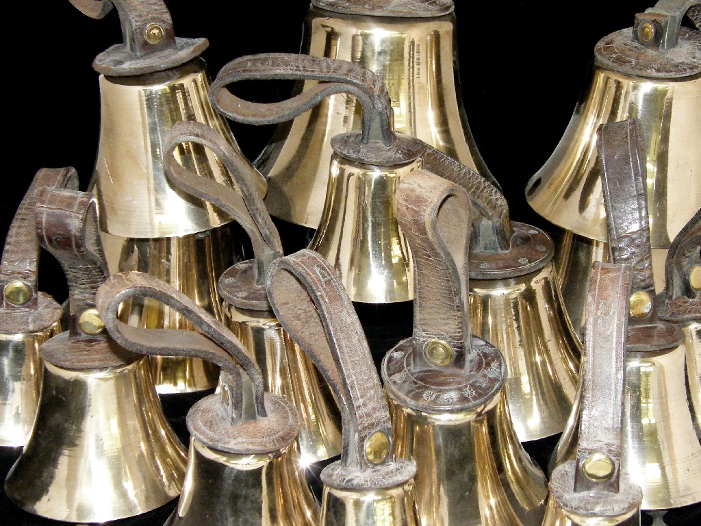 Appraisal: Set of sixteen graduated brass hand bells with leather strap