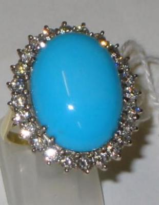 Appraisal: A TURQUOISE AND DIAMOND DRESS RING the large oval cabochon