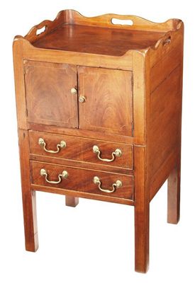 Appraisal: A mahogany 'tray top' bedside cupboard the commode replaced with