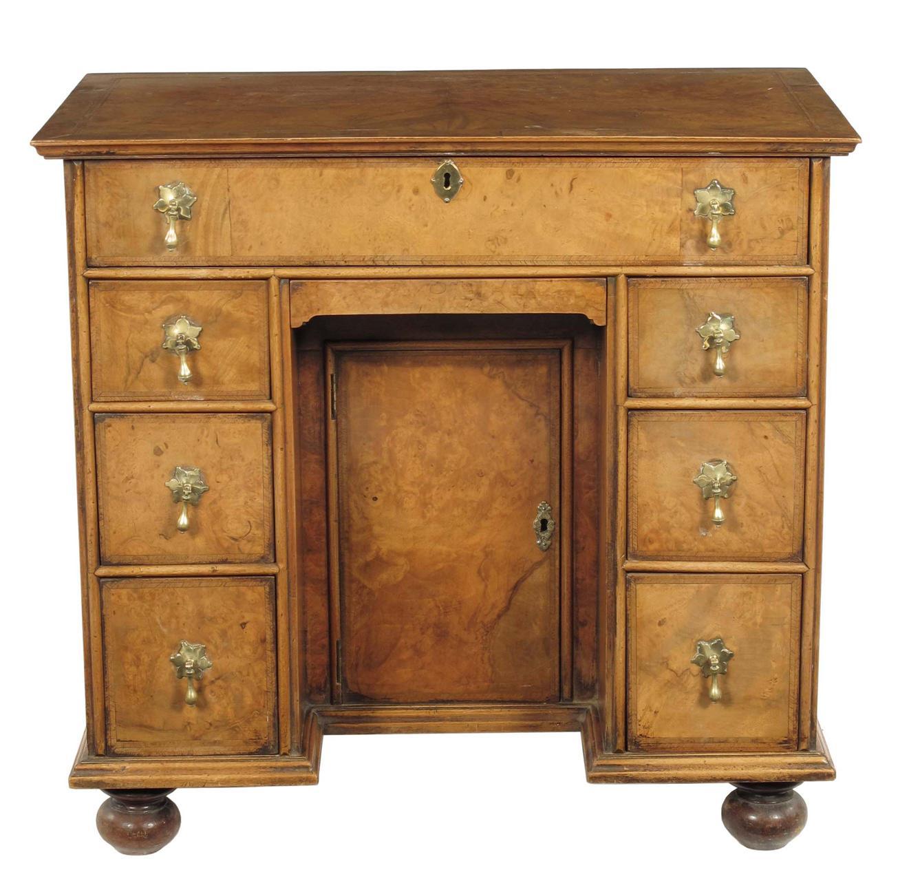 Appraisal: A walnut kneehole desk in Queen Anne style