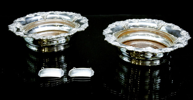 Appraisal: A pair of silver plated wine coasters together with a