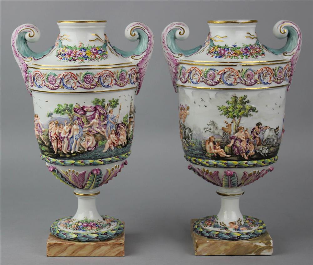 Appraisal: PAIR OF ITALIAN PORCELAIN PISTOL HANDLE URNS possibly by Nove