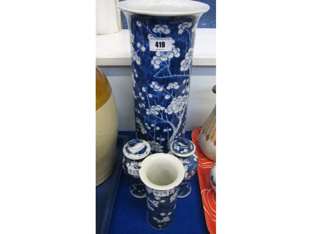 Appraisal: Lot comprising two prunus decorated vases with lids and two