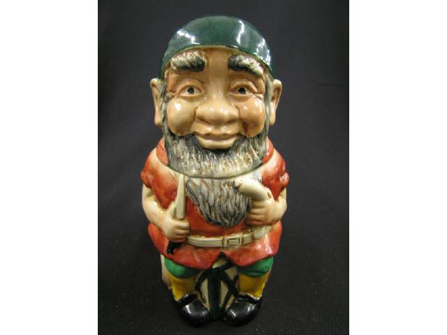 Appraisal: Goebel German Figural Pottery Stein gnome seated with knife sausage