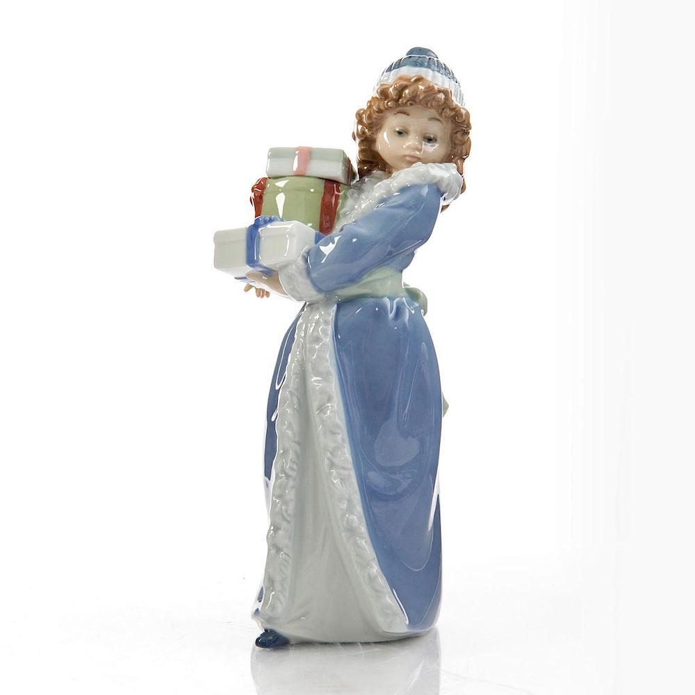 Appraisal: NAO BY LLADRO FIGURINE CHRISTMAS TIME Young girl with Christmas