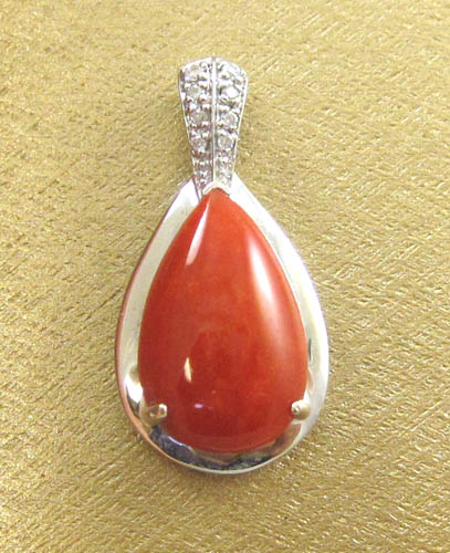 Appraisal: CORAL DIAMOND AND FOURTEEN KARAT WHITE GOLD PENDANT set with