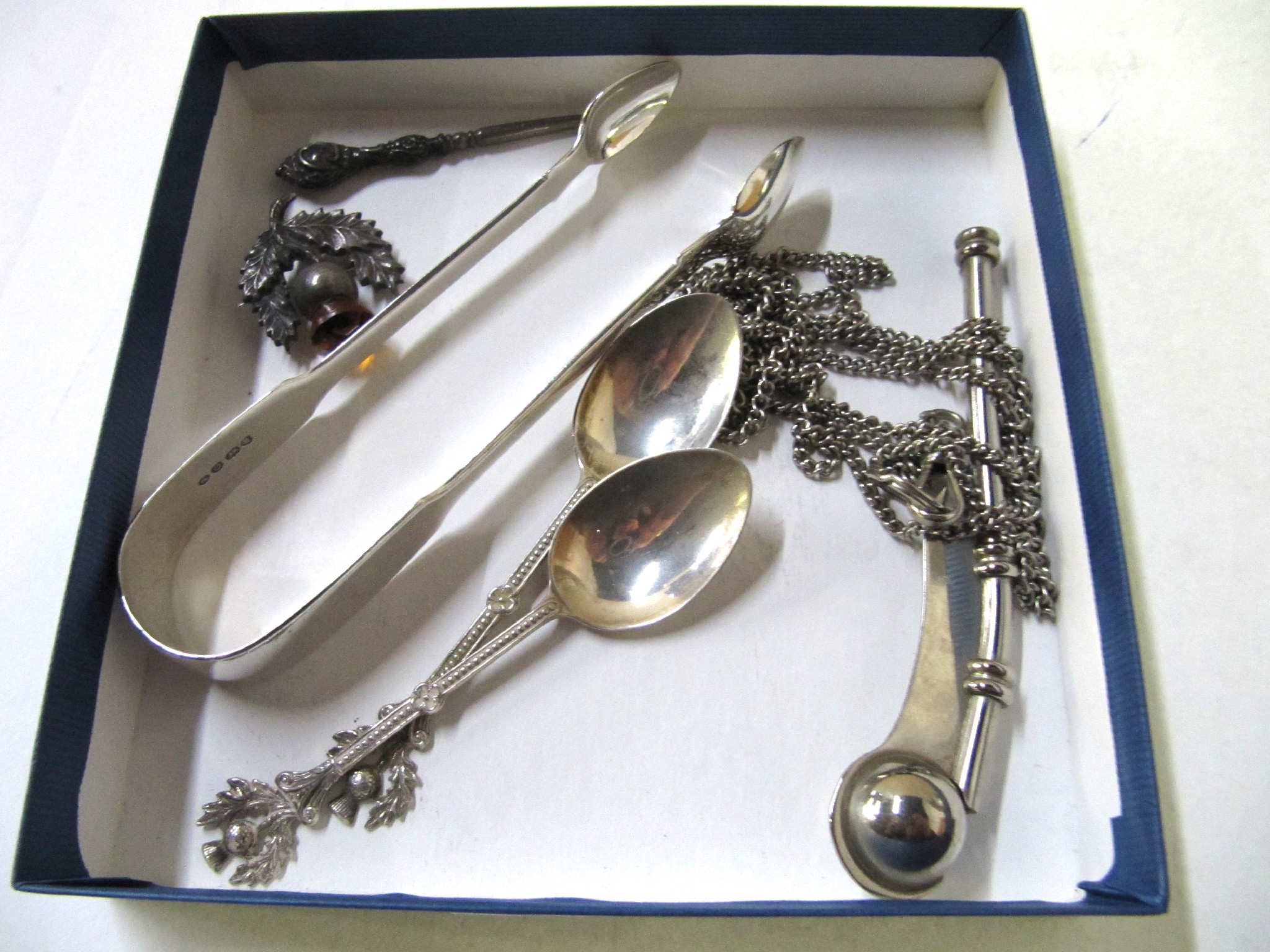 Appraisal: A lot comprising silver sugar tongs two silver spoons a