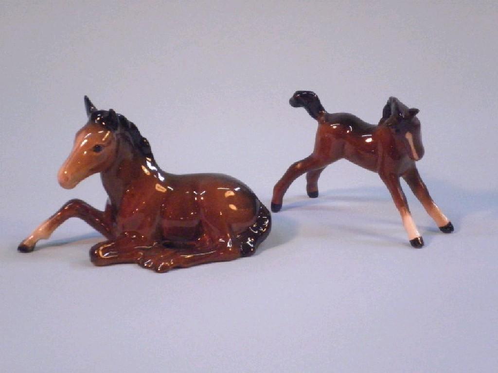 Appraisal: Beswick A brown foal stretched and a seated foal