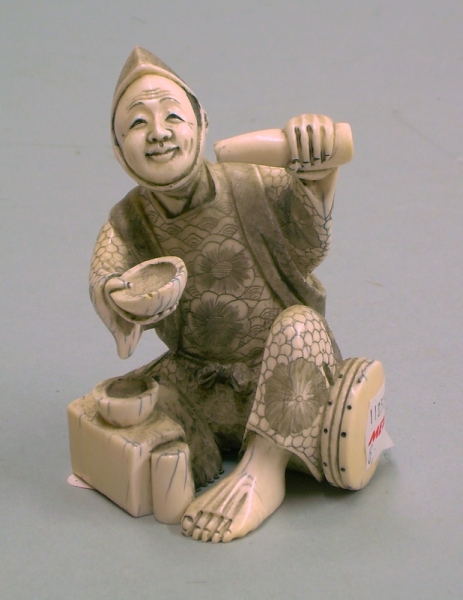 Appraisal: Japanese Carving of seated man with bottle pouring into bowl