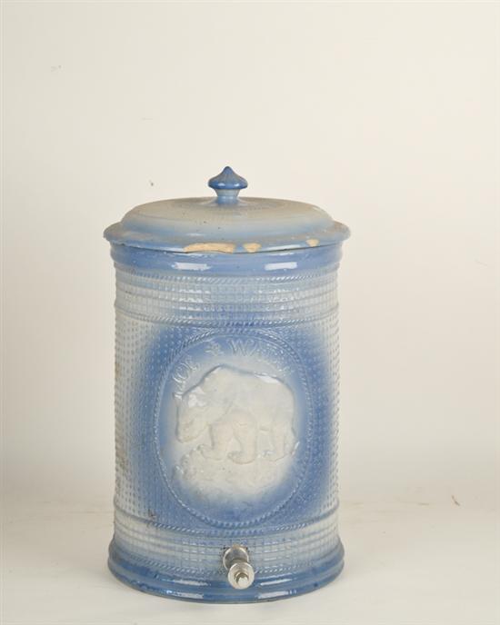 Appraisal: A Stoneware Water Cooler having a relief design of a