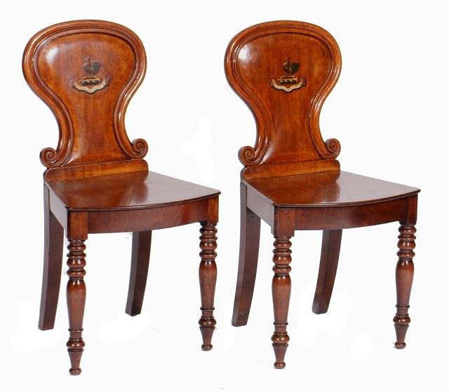 Appraisal: A PAIR OF TH CENTURY MAHOGANY HALL CHAIRS the scroll