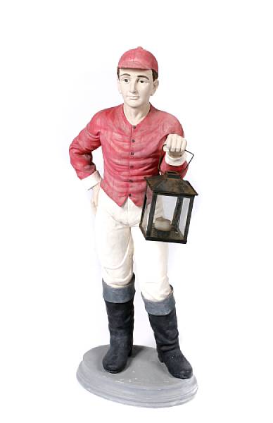 Appraisal: A paint decorated cast iron lawn jockey together with another