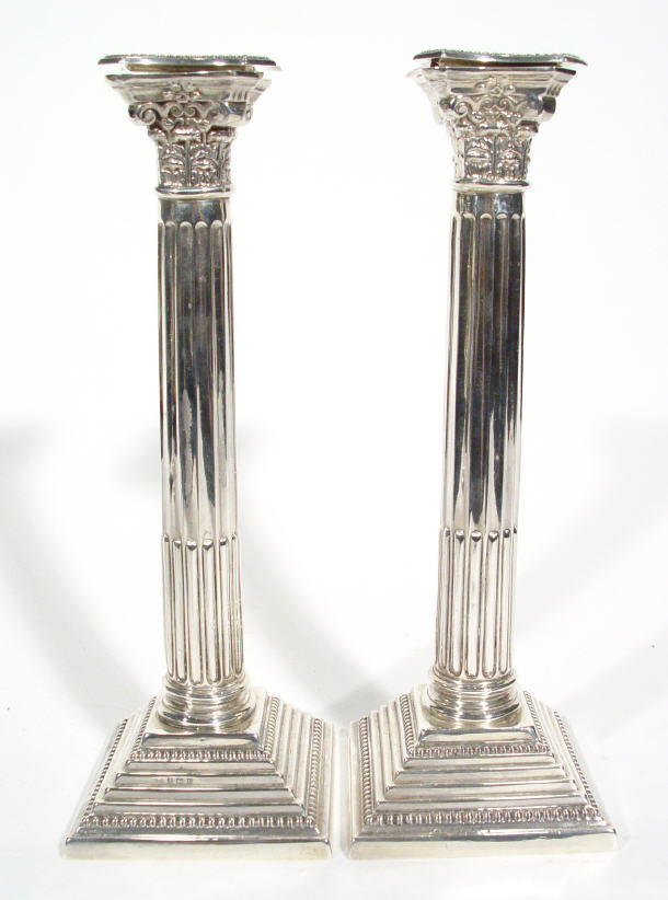 Appraisal: Pair of square based reeded column candlesticks with acanthus moulded