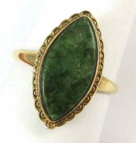 Appraisal: GREEN JADE AND TEN KARAT GOLD RING featuring a single