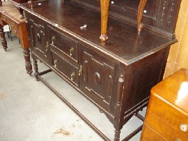 Appraisal: A Jacobean style stained oak sideboard with carved back