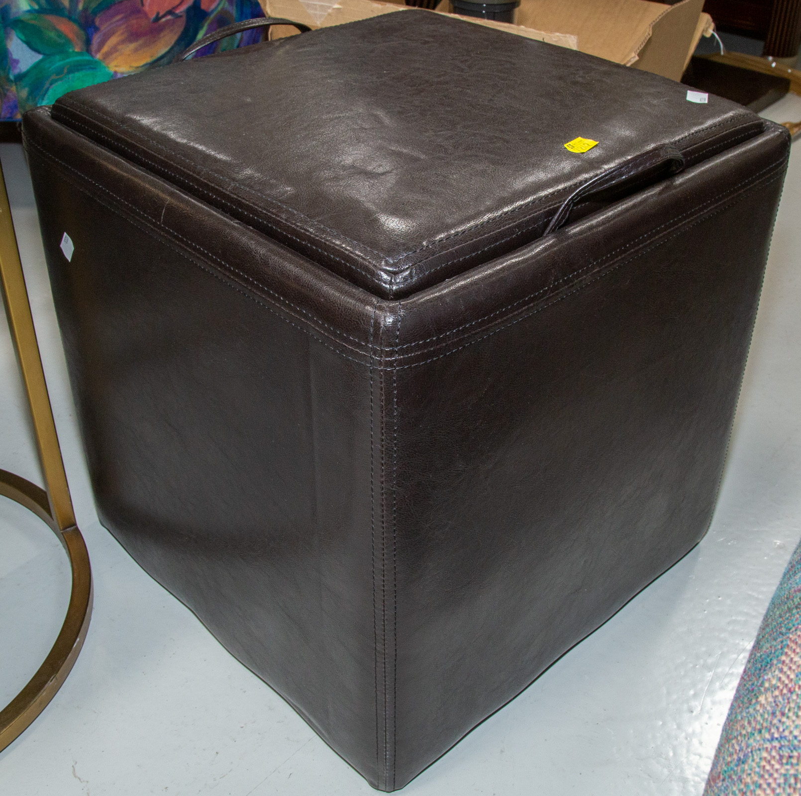 Appraisal: STORAGE OTTOMAN With padded imitation leather upholstery in Sq