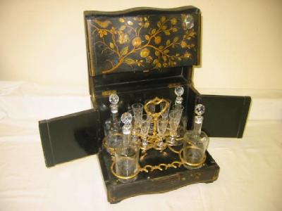 Appraisal: A VICTORIAN LACQUERED DECANTER CASE of serpentine oblong form gilded