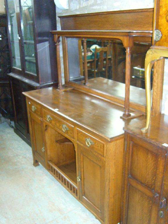 Appraisal: An Edwardian oak sideboard with raised mirror back with column