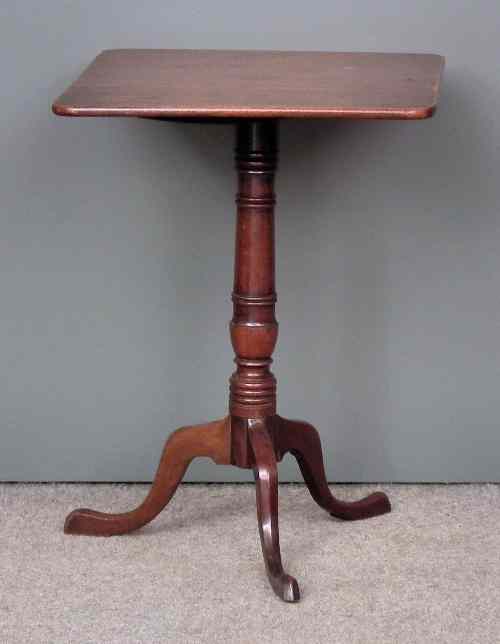 Appraisal: A George III mahogany square tripod table on turned centre