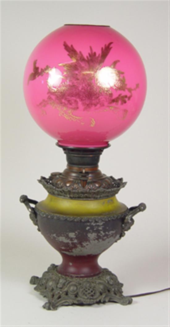 Appraisal: Patinated Metal Banquet Lamp with Shade Circa Pink cased glass