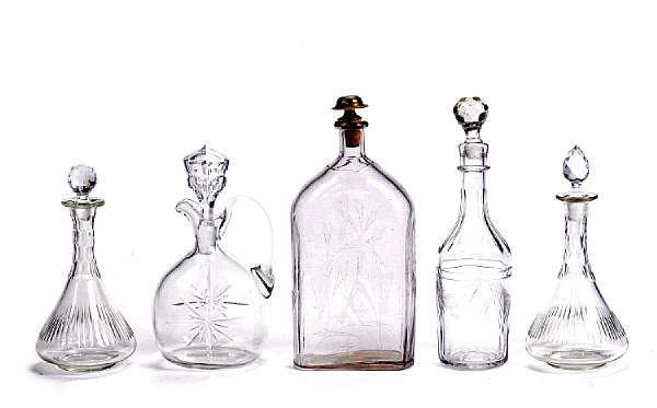 Appraisal: An assembled group of five cut and engraved glass decanters