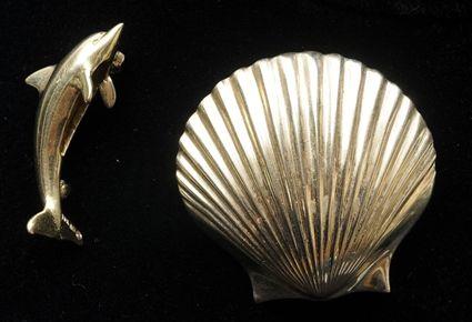 Appraisal: Two Small Brooches The dolphin marked K in the scallop