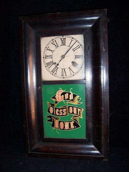 Appraisal: An American wall clock in an ebonised case the glazed